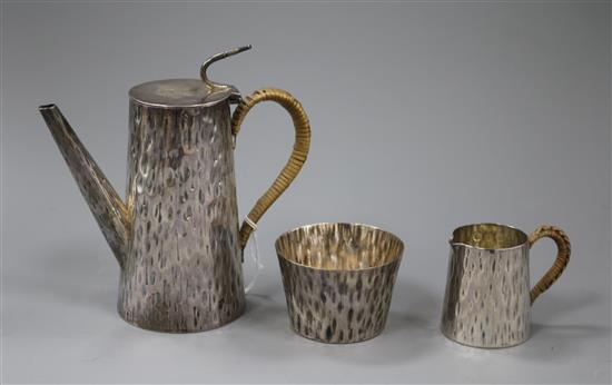 A matched late Victorian hammered silver three piece coffee set by Hukin & Heath, Birmingham, 1895 & London, 1891, gross 11.5 oz.